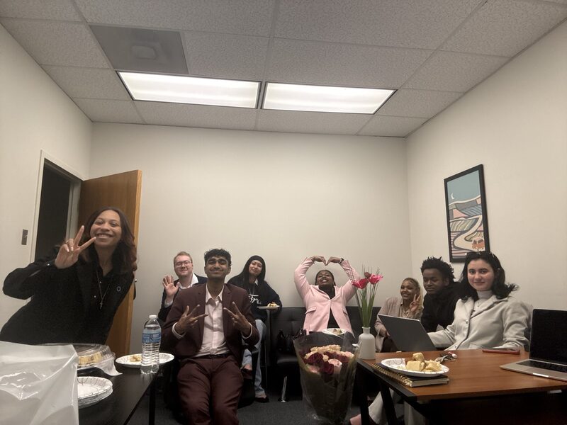 Inspire Core team making heart shapes and celebrating together in the office