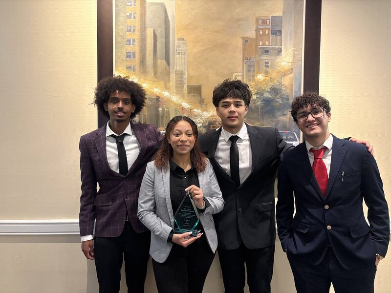 Inspire Core team members holding an award at a recognition conference