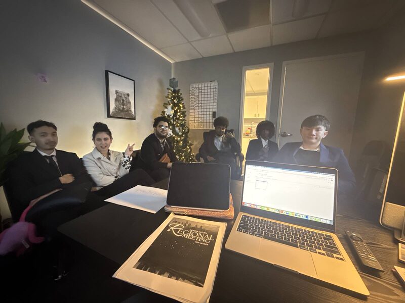 The Inspire Core team gathered around a table during a regional meeting